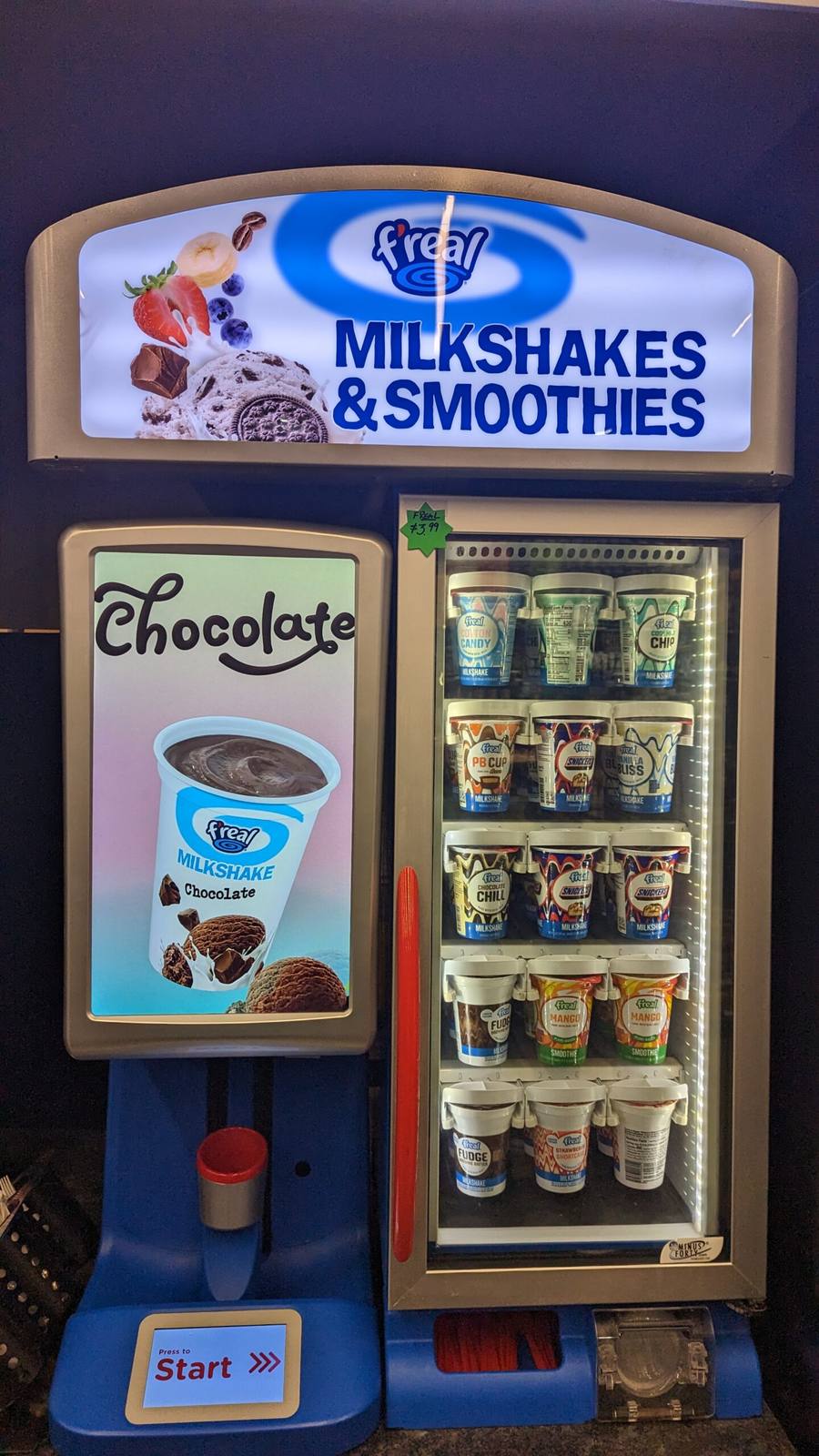 The f'real self-serve blending bar — a freezer of milkshake and smoothie cups beside the blender station