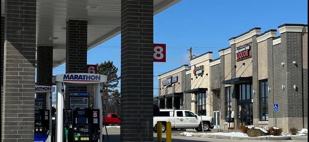The Marathon forecourt and Hometown Liquor storefront in Haslett, Michigan