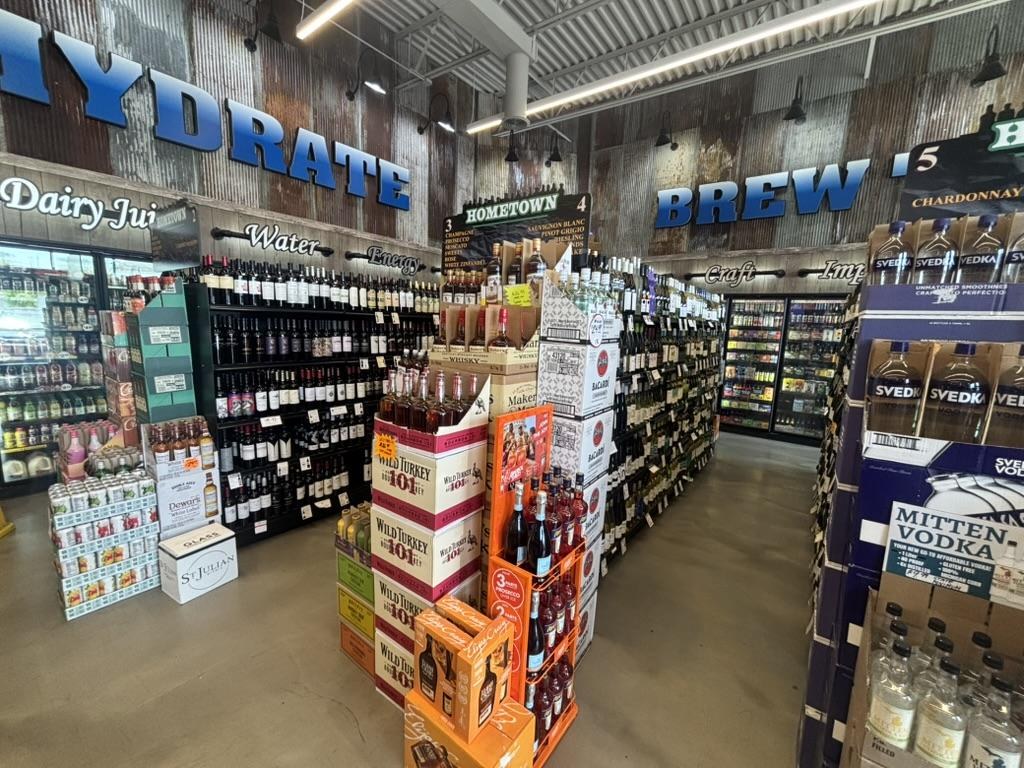 Vodka and hydrate aisle with Mitten Vodka and Hometown Brew signage