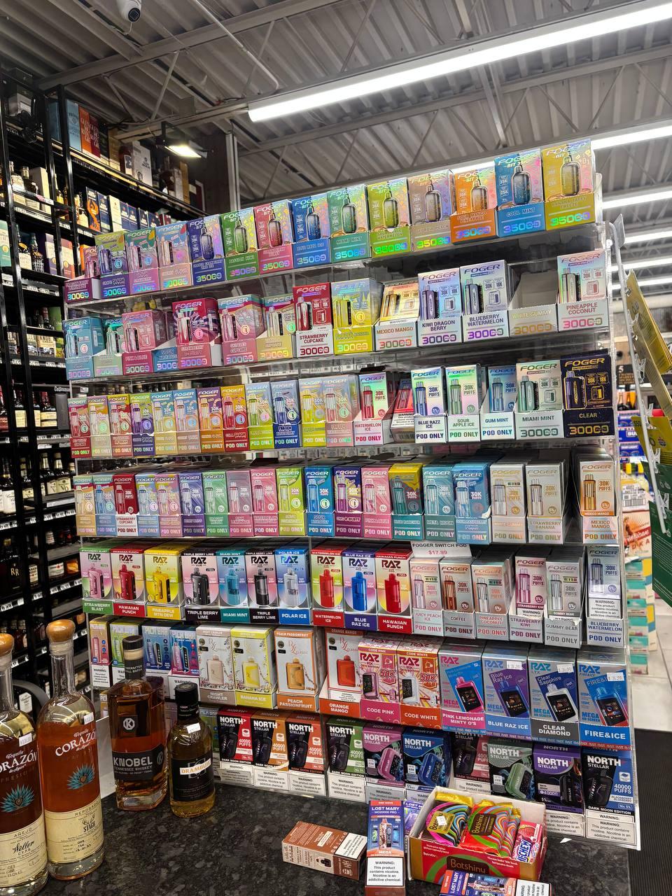Floor-to-ceiling vape display wall with hundreds of options