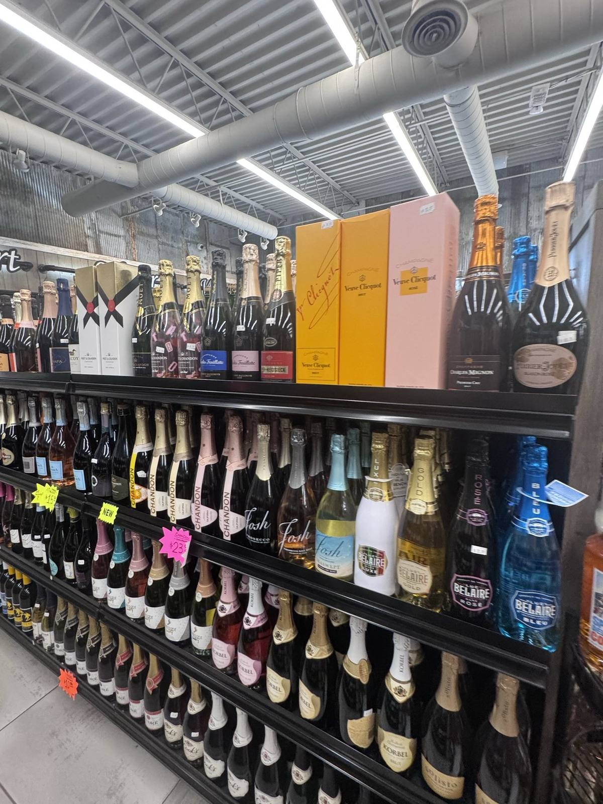 The champagne and sparkling wine shelf — limited and seasonal bottles lined up under the cooler lights
