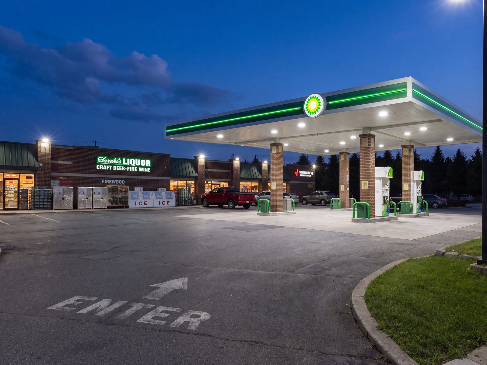 The family's Wixom store at night — Saroki's Liquor beside the lit BP forecourt